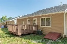 a view of backyard with deck and garden