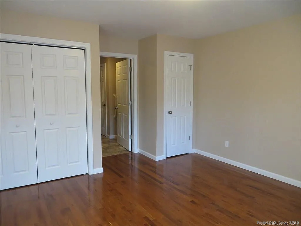 4 Grove Street Moodus, CT 06469 - Photo 6 of 11 a view of an empty room with wooden floor