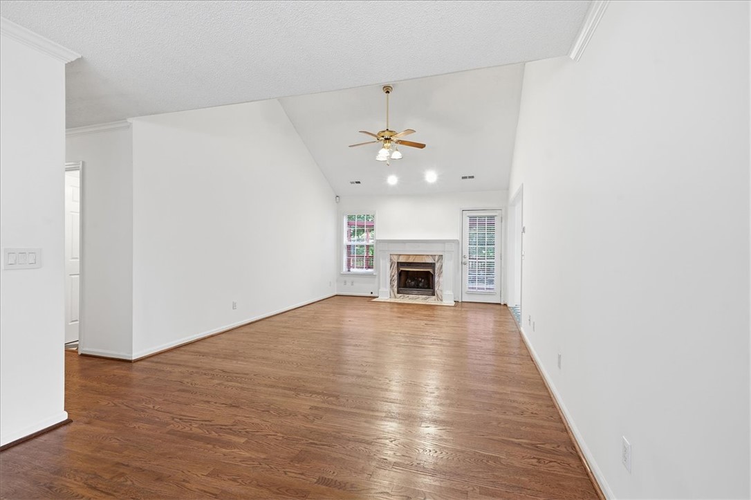 1052 Madden Bridge Road Central, SC 29630 - Photo 19 of 50 Hardwood floors and a classic fireplace anchor this airy, vaulted living space.