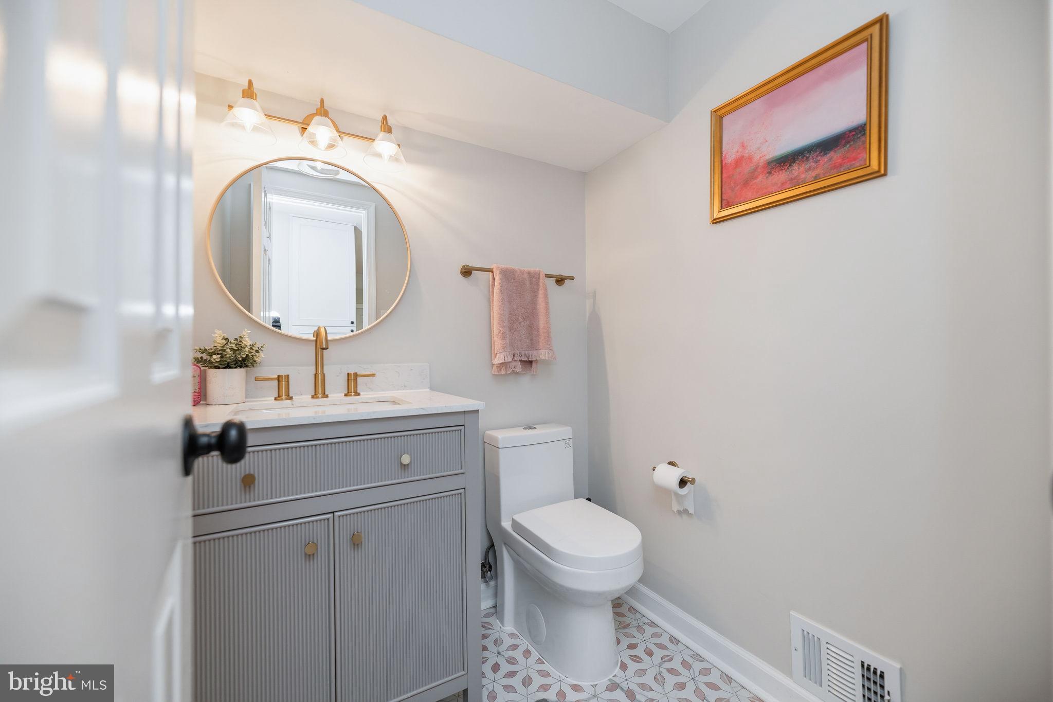 7603 Modisto Lane Springfield, VA 22153 - Photo 9 of 57 a bathroom with a toilet a sink and a mirror