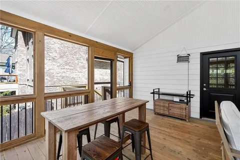 a kitchen with granite countertop a table chairs stainless steel appliances and cabinets