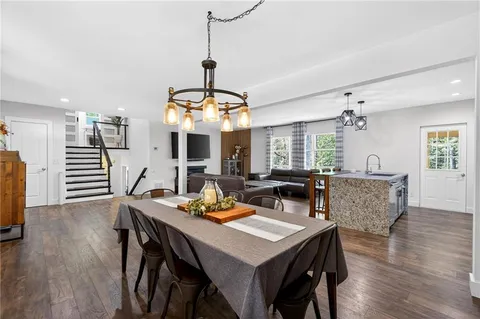 a view of a dining room with furniture window and wooden floor