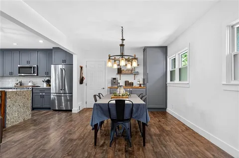 a kitchen with stainless steel appliances granite countertop a refrigerator and a sink