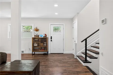 a view of entryway and hall with wooden floor