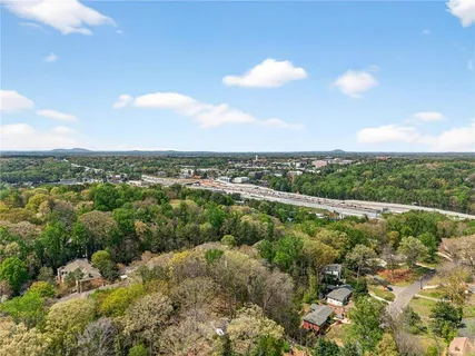 an aerial view of residential houses with outdoor space and trees