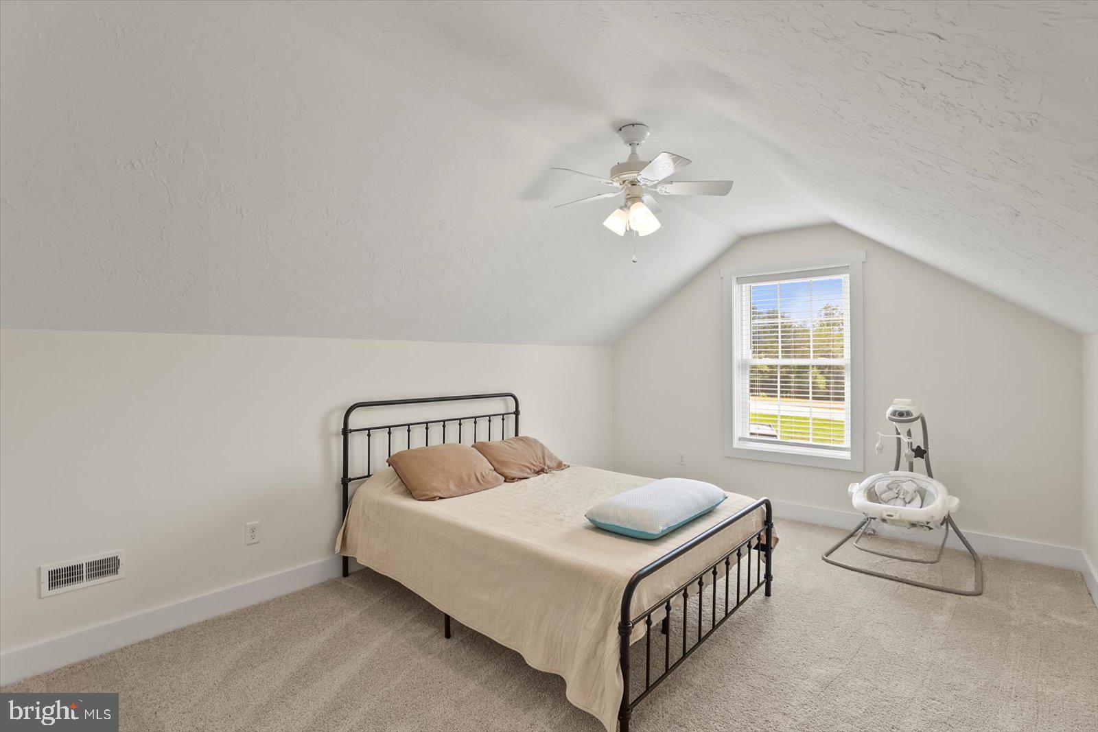 4340 Lee Road Glenville, PA 17329 - Photo 27 of 42 a bedroom with a bed and a chandelier