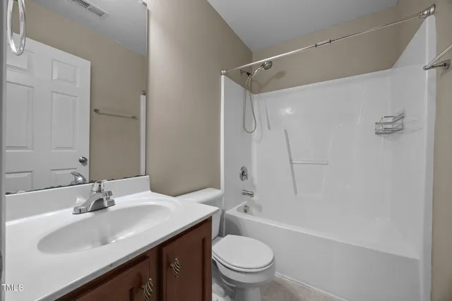 a bathroom with a sink toilet tub and shower