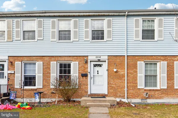 a front view of a house with a yard and glass windows