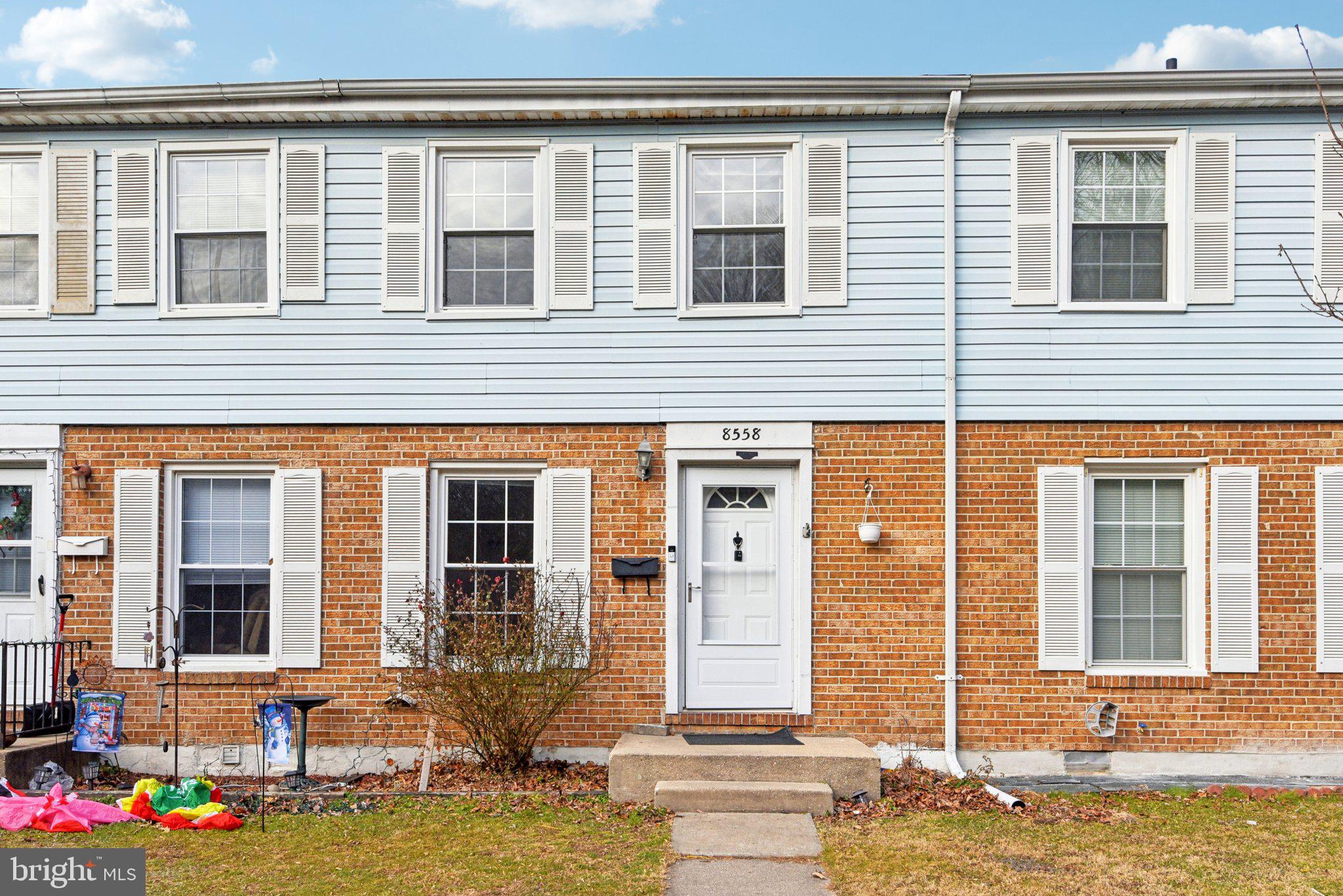 8558 Hydra Lane, Unit 11J Nottingham, MD 21236 - Photo 1 of 1 a front view of a house with a yard and glass windows