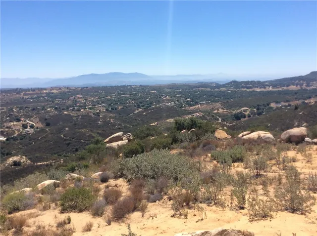 a backyard of a house with a yard and outdoor seating