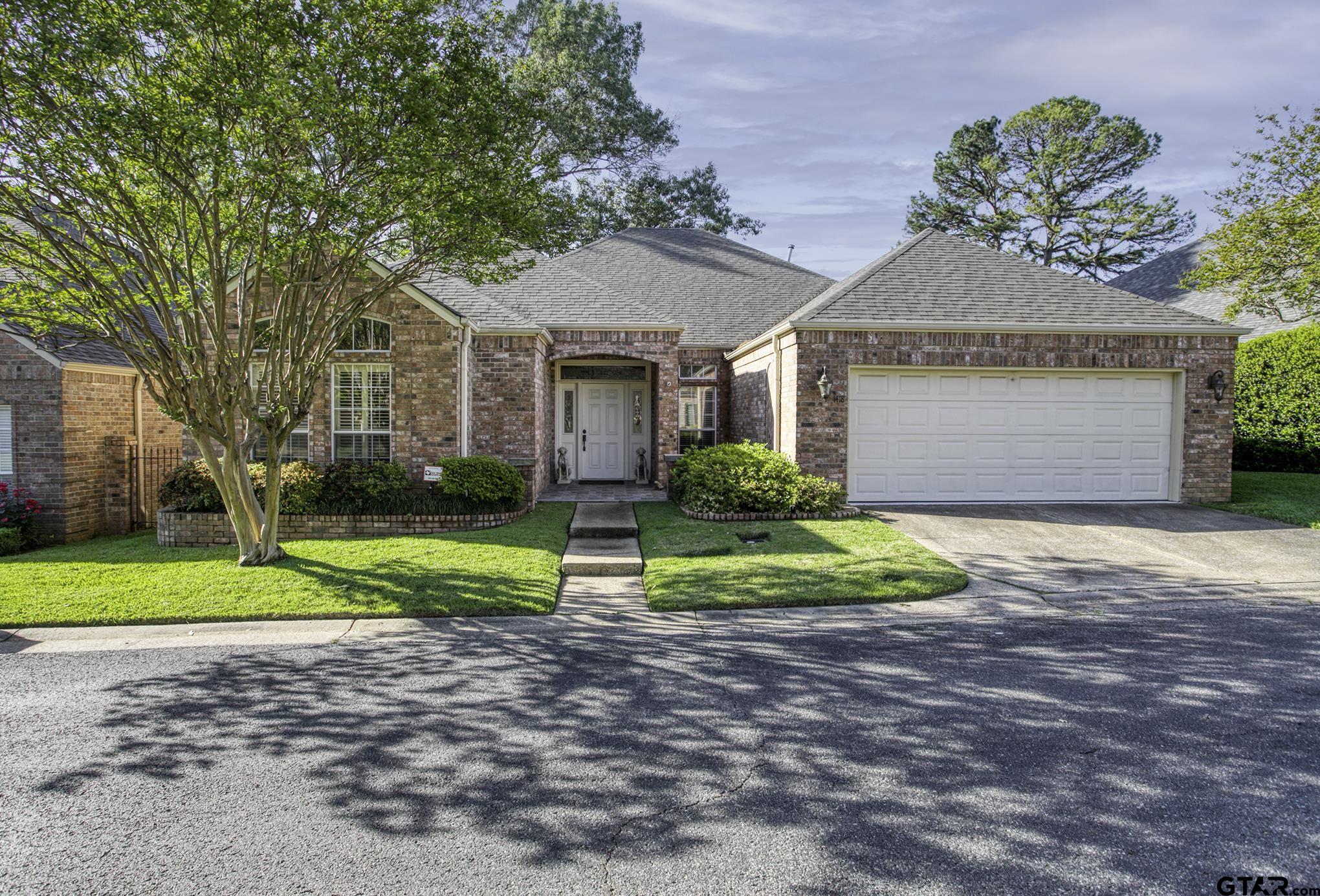 1418 Hollytree Place Tyler, TX 75703 - Photo 1 of 46 a front view of a house with a yard and garage
