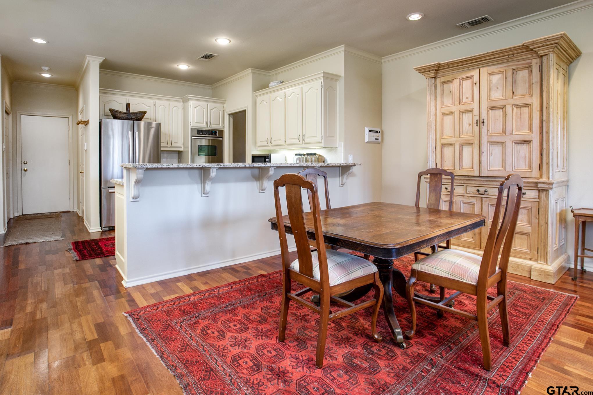 1418 Hollytree Place Tyler, TX 75703 - Photo 16 of 46 a view of a dining room with furniture and a rug