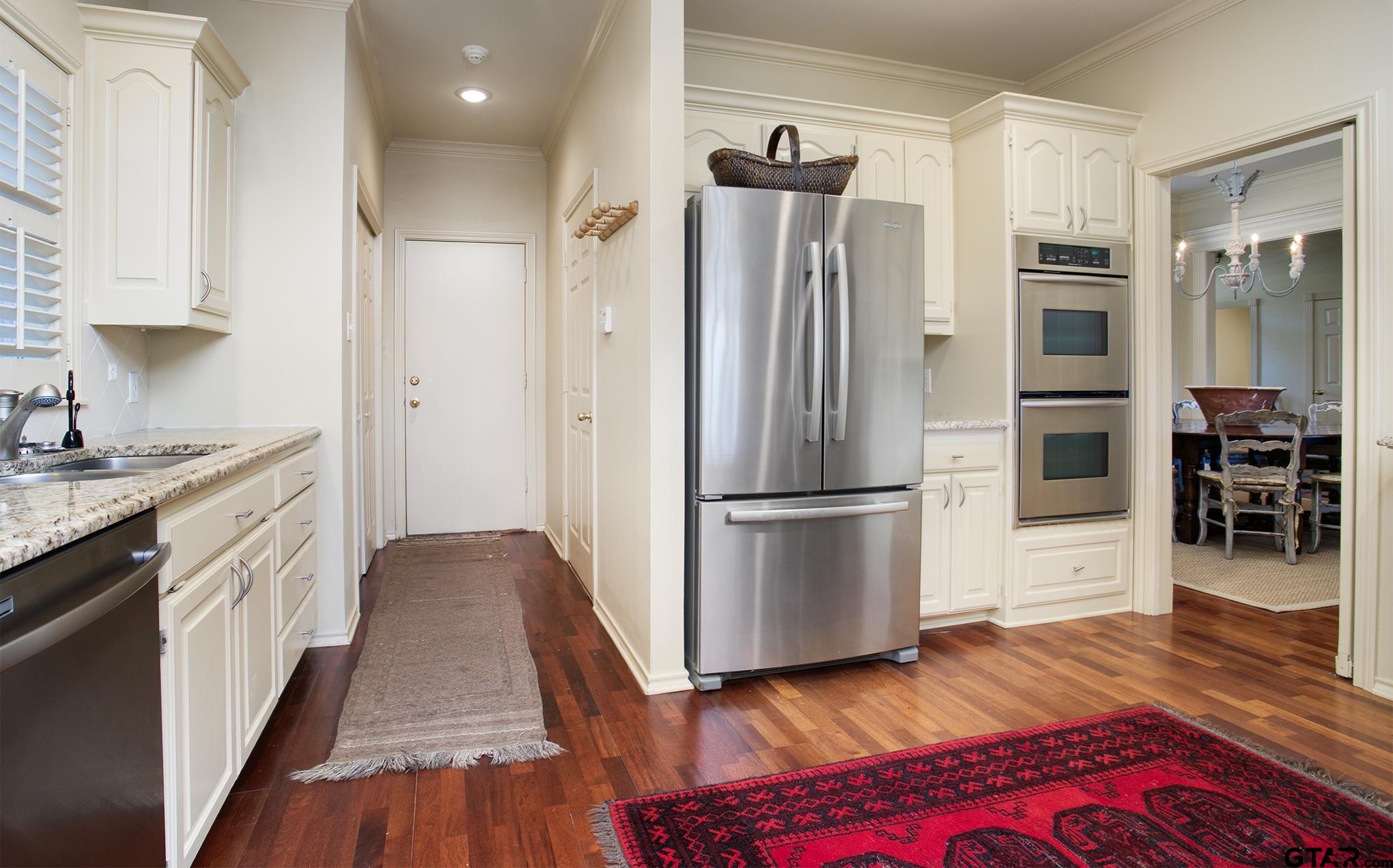 1418 Hollytree Place Tyler, TX 75703 - Photo 17 of 46 a kitchen with stainless steel appliances a refrigerator and a stove top oven