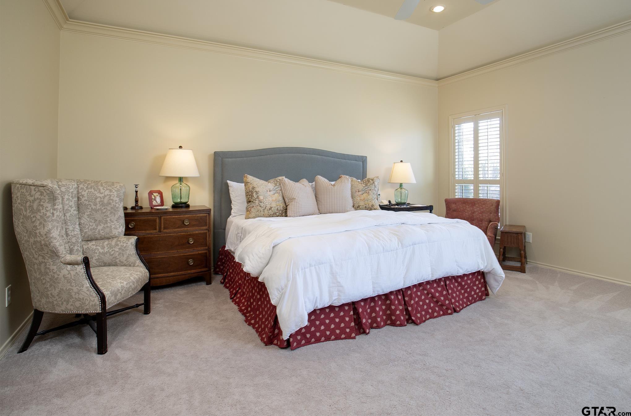 1418 Hollytree Place Tyler, TX 75703 - Photo 22 of 46 a spacious bedroom with a bed and a couch