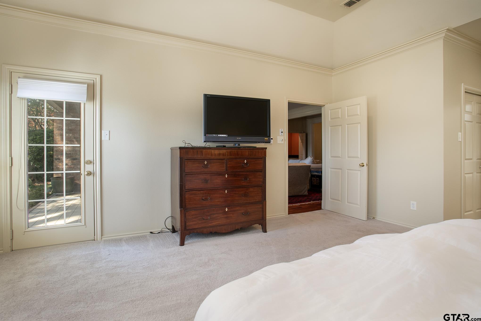 1418 Hollytree Place Tyler, TX 75703 - Photo 23 of 46 a bed room with closet and flat screen tv