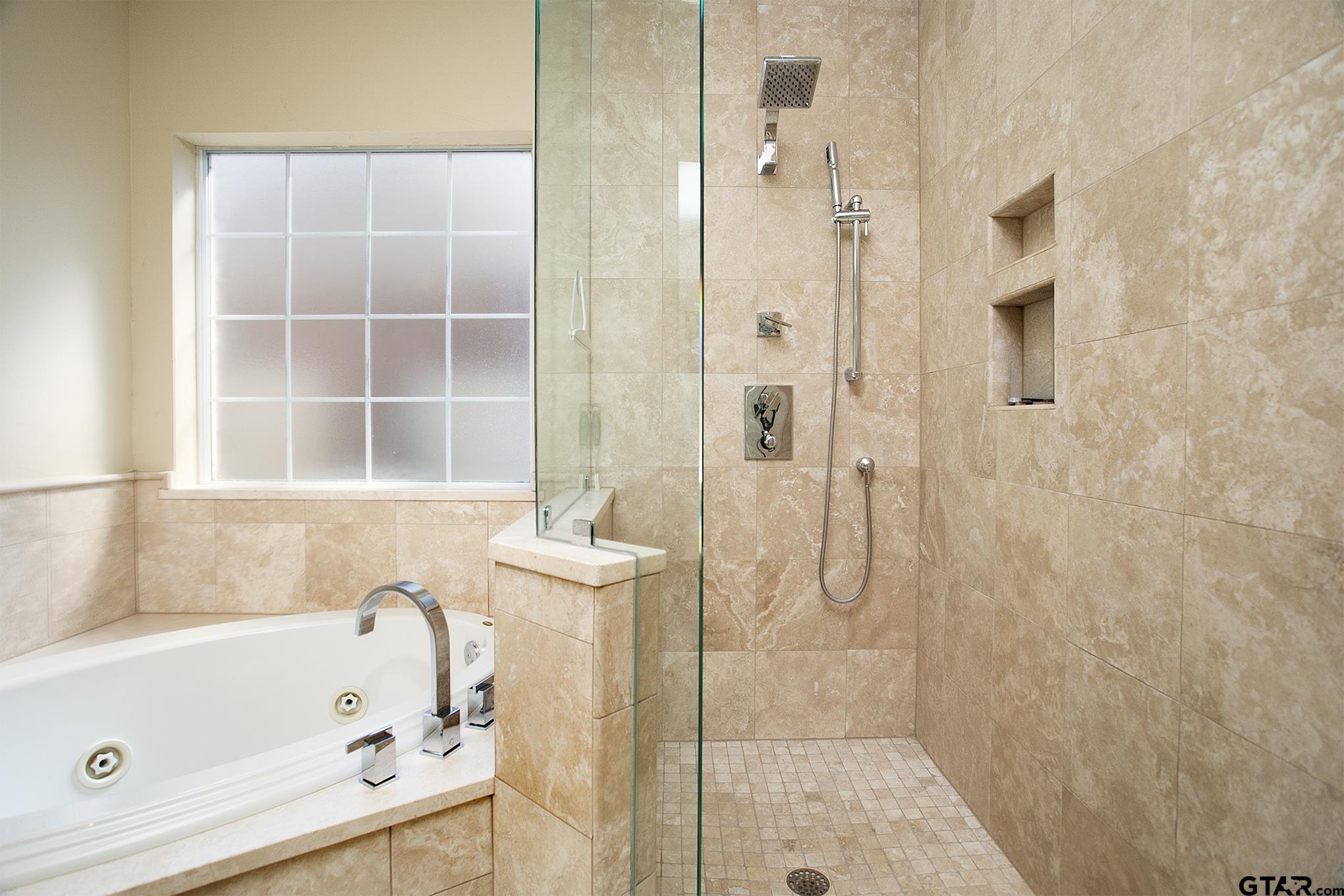 1418 Hollytree Place Tyler, TX 75703 - Photo 26 of 46 a bathroom with a bathtub and a shower