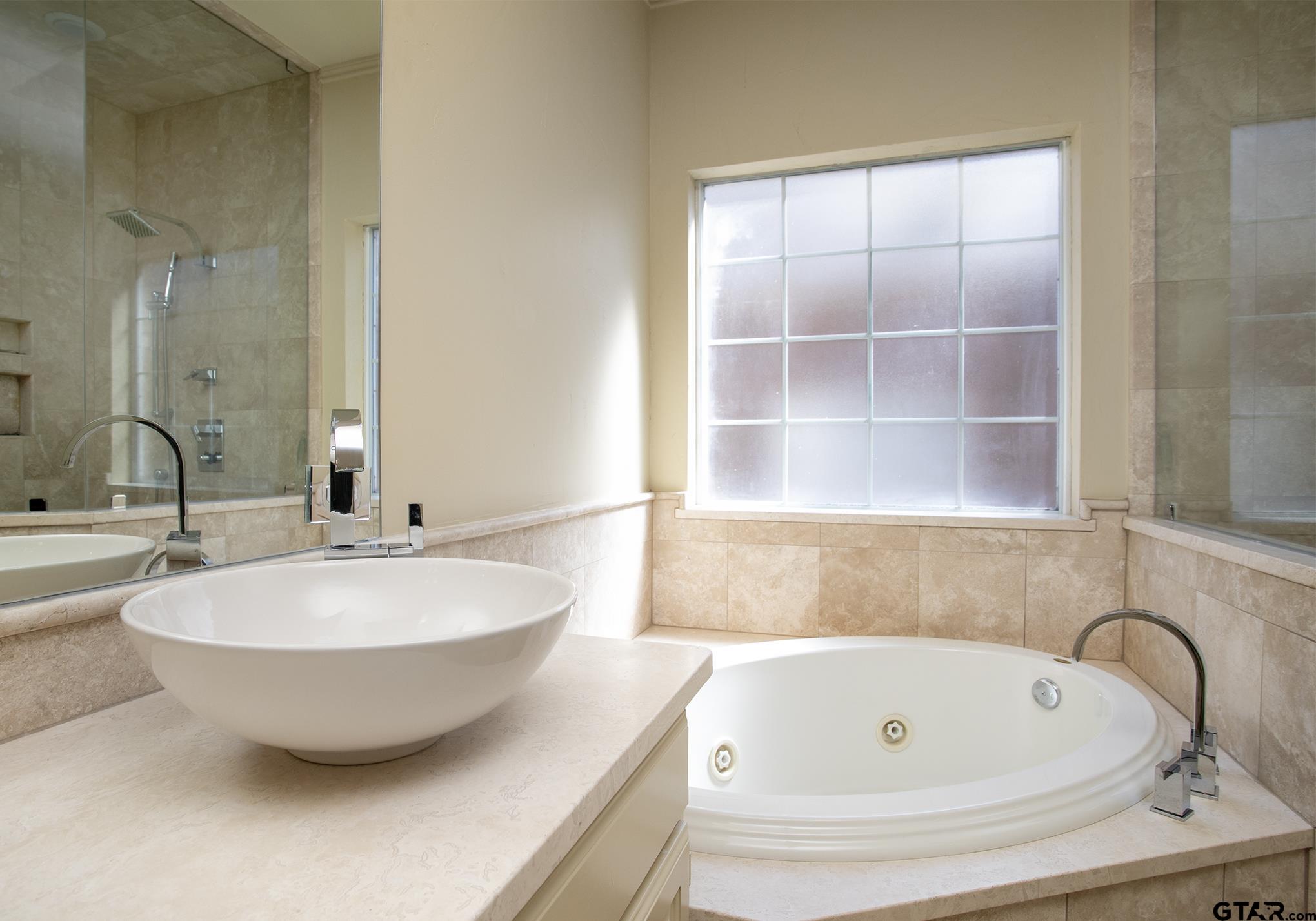 1418 Hollytree Place Tyler, TX 75703 - Photo 27 of 46 a bathroom with a sink and a bathtub