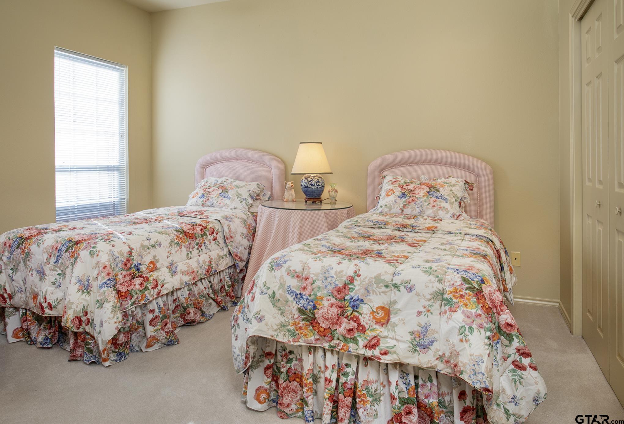 1418 Hollytree Place Tyler, TX 75703 - Photo 28 of 46 a bedroom with two beds and a window