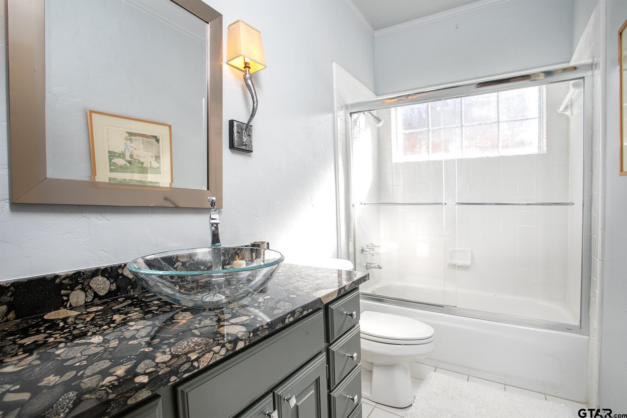 1418 Hollytree Place Tyler, TX 75703 - Photo 29 of 46 a bathroom with a granite countertop sink toilet and shower