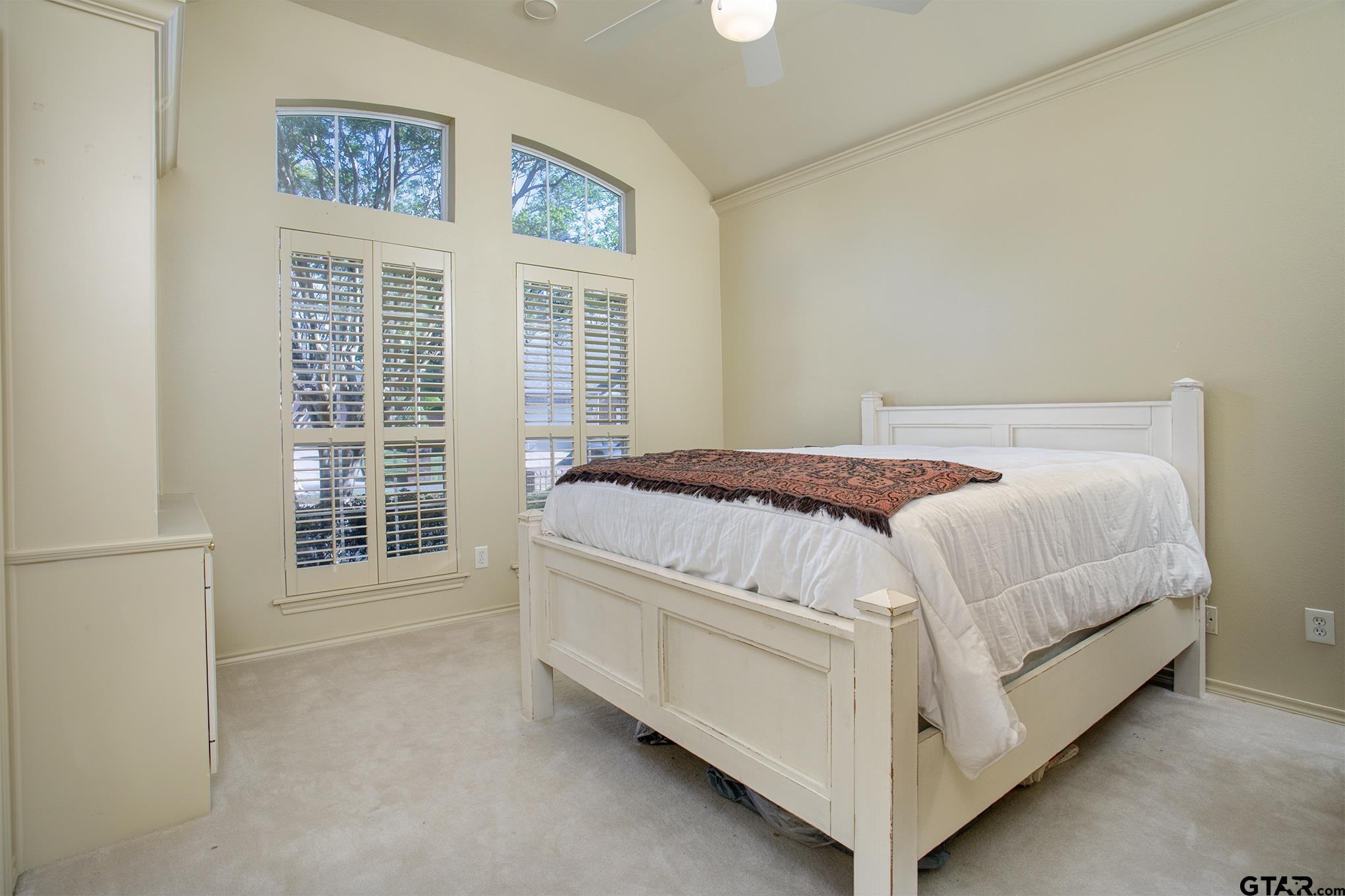 1418 Hollytree Place Tyler, TX 75703 - Photo 31 of 46 a bed sitting in a bedroom next to a window