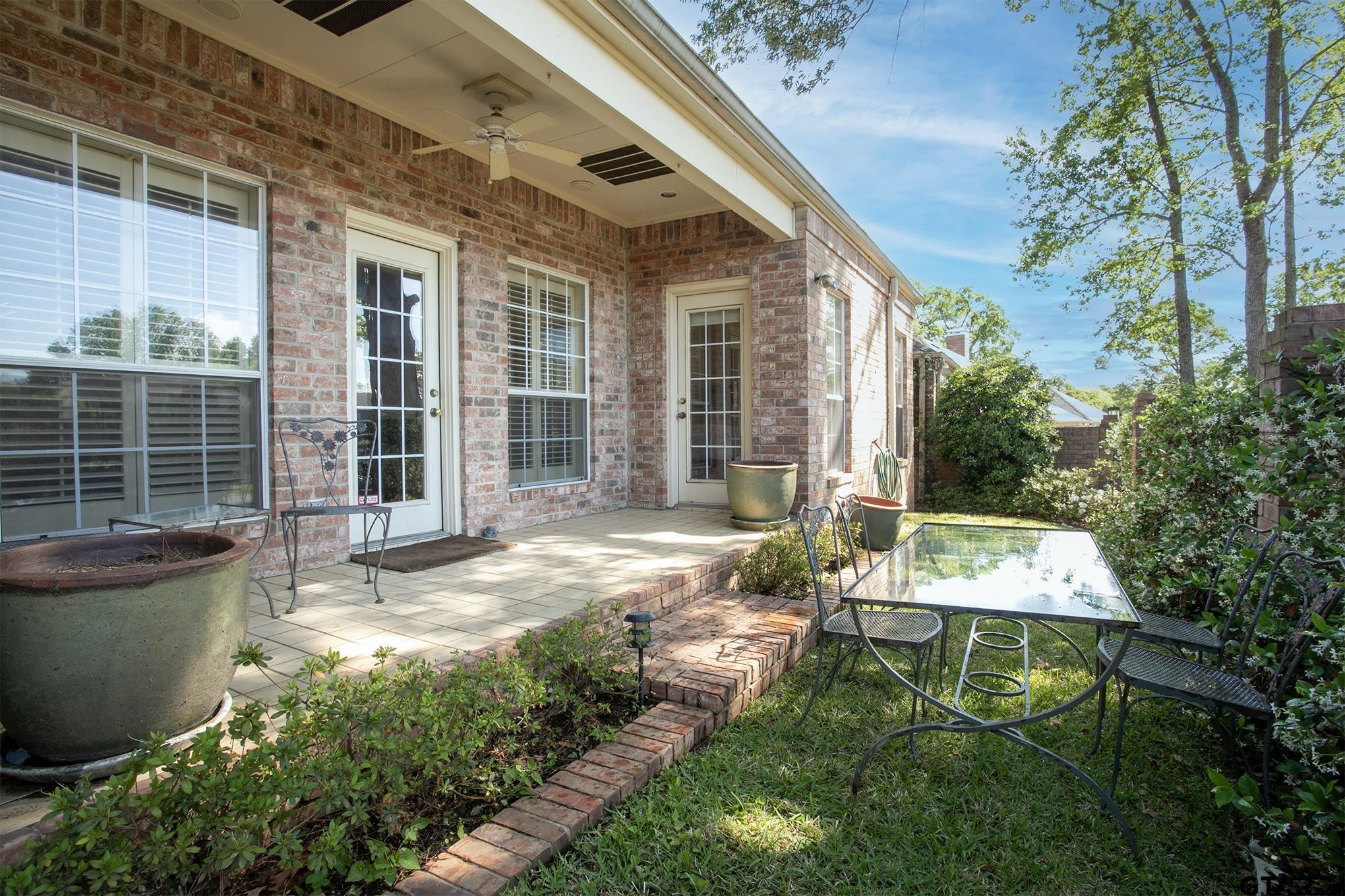 1418 Hollytree Place Tyler, TX 75703 - Photo 33 of 46 a backyard of a house with yard and outdoor seating