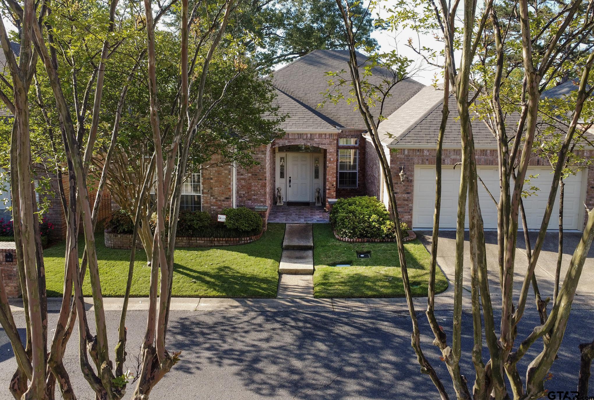 1418 Hollytree Place Tyler, TX 75703 - Photo 34 of 46 a view of a house with backyard and a tree
