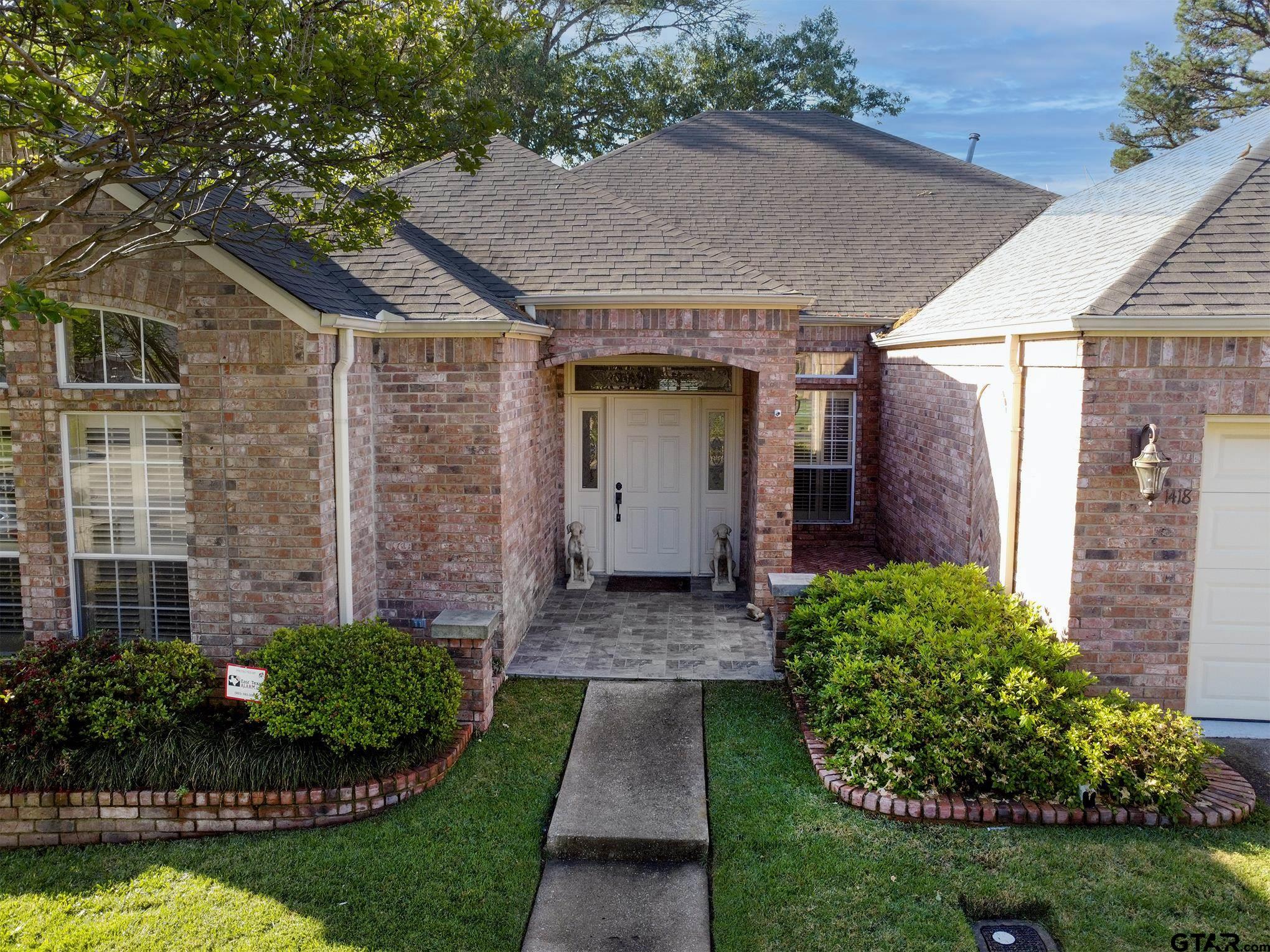 1418 Hollytree Place Tyler, TX 75703 - Photo 36 of 46 a front view of a house with garden