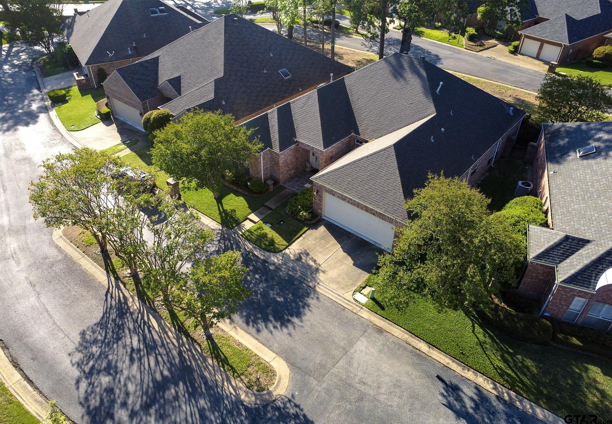 1418 Hollytree Place Tyler, TX 75703 - Photo 40 of 46 an aerial view of a house with a yard and greenery space