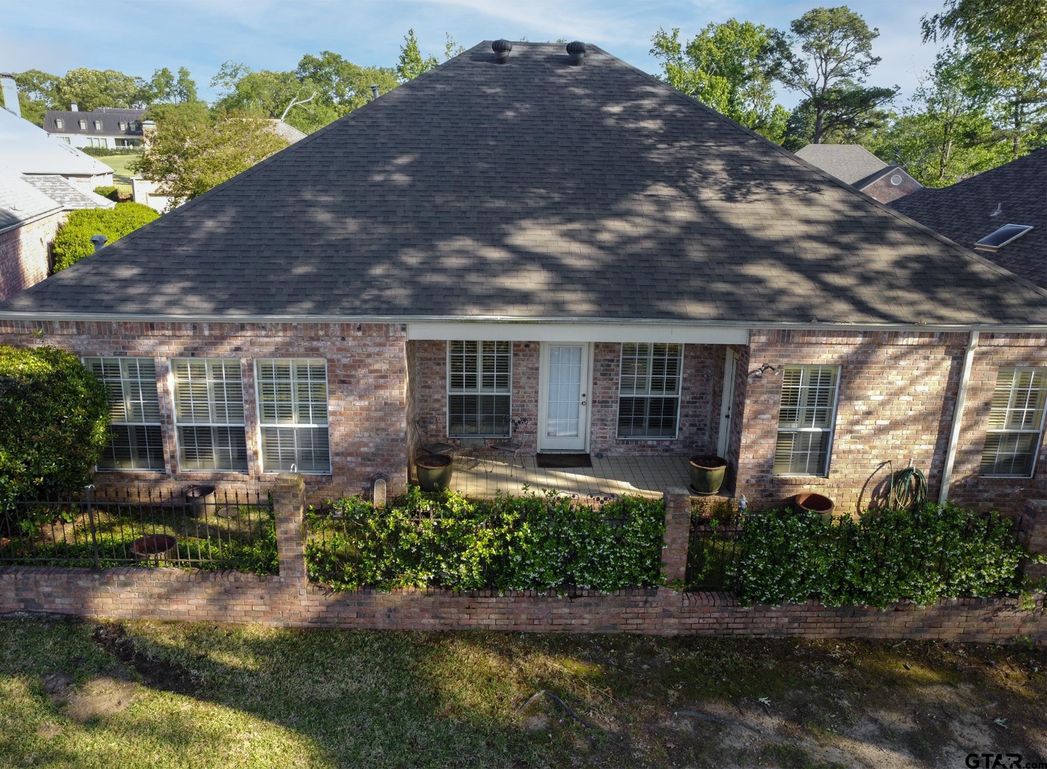 1418 Hollytree Place Tyler, TX 75703 - Photo 41 of 46 front view of house with a yard and potted plants