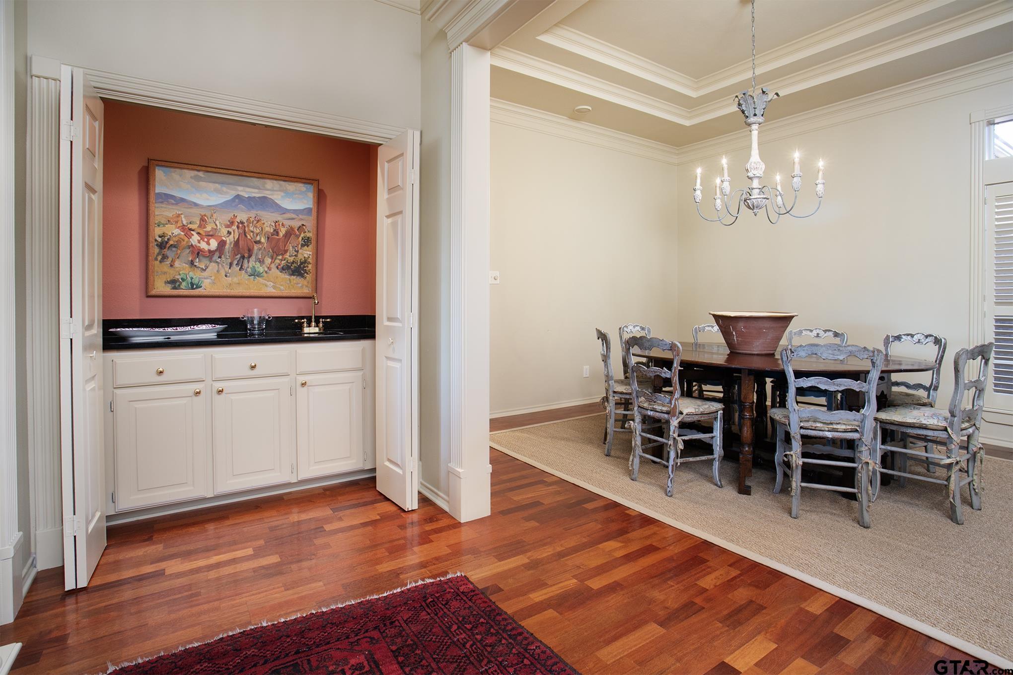 1418 Hollytree Place Tyler, TX 75703 - Photo 7 of 46 a view of a dining room with furniture wooden floor and chandelier