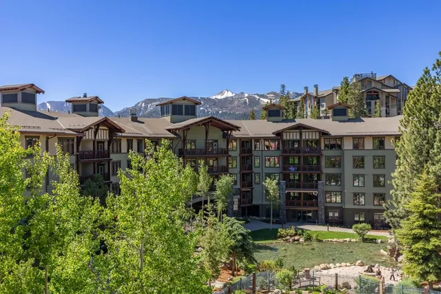 a front view of a residential apartment building with a yard