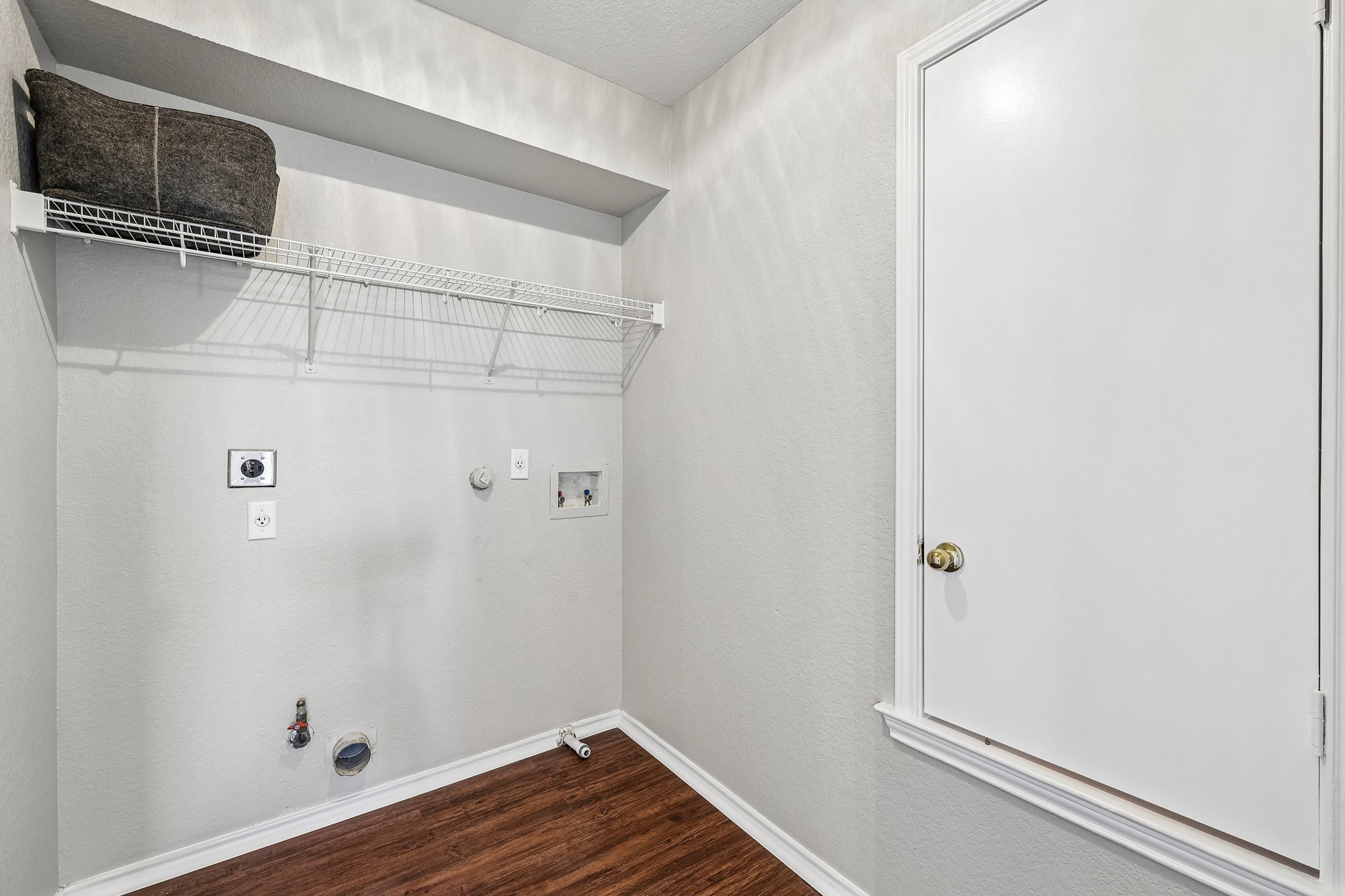 616 Scheel Road Kyle, TX 78640 - Photo 32 of 39 Functional laundry space featuring convenient wire shelving and durable flooring.