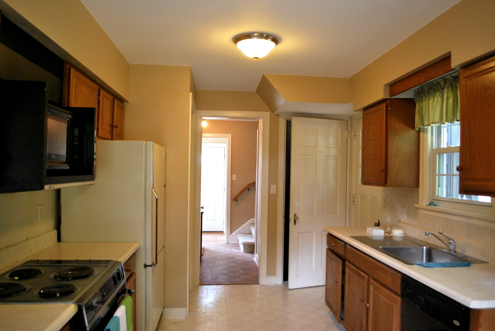 1057 North 8th Street Rochelle, IL 61068 - Photo 14 of 46 a kitchen with a sink and a refrigerator