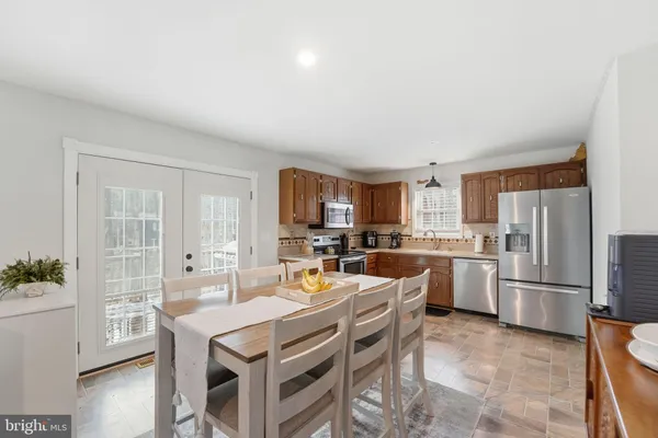 a kitchen with granite countertop stainless steel appliances a stove a microwave and cabinets