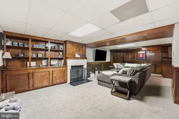 a living room with furniture and a fireplace