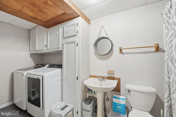 a view of deck with a large window and wooden fence