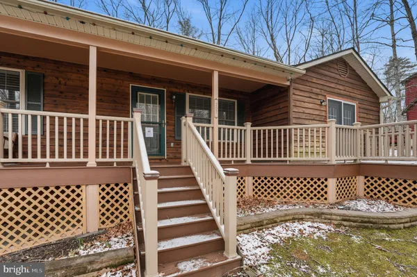 a view of a house with wooden fence