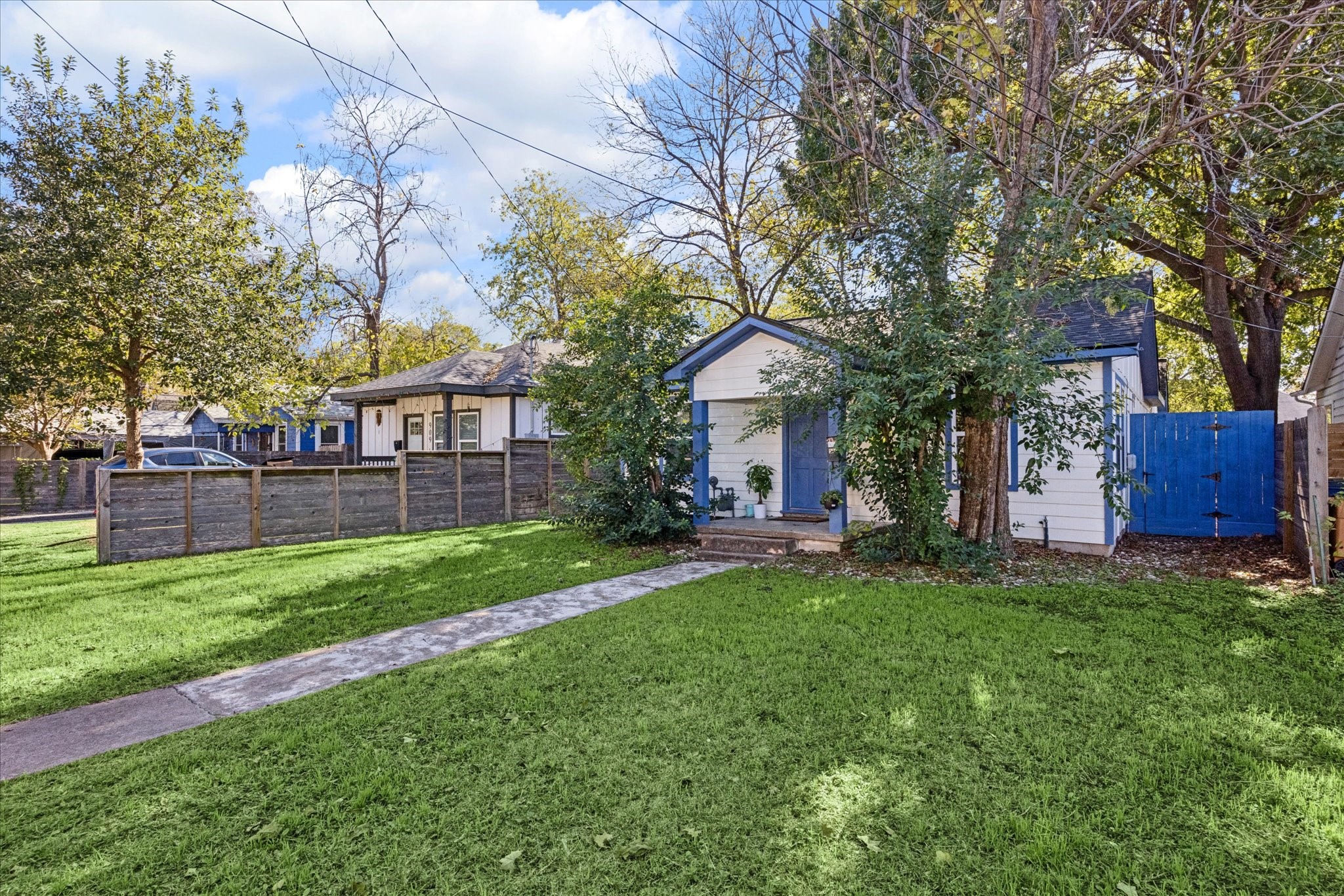 a view of a house with a yard and a tree