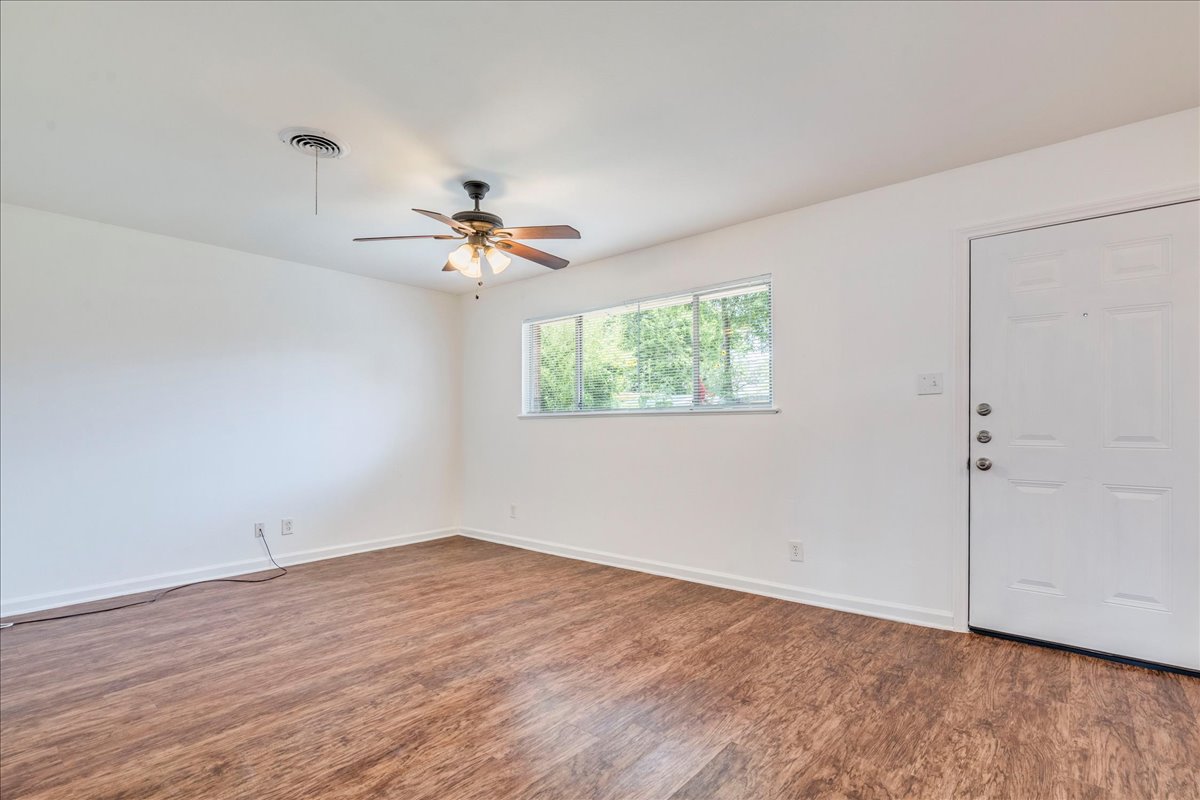 1417 Braes Ridge Drive, Unit B Austin, TX 78723 - Photo 5 of 22 a view of a room with wooden floor and a ceiling fan