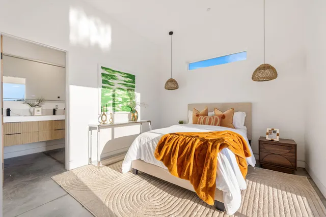 a bedroom with a large bed and a window