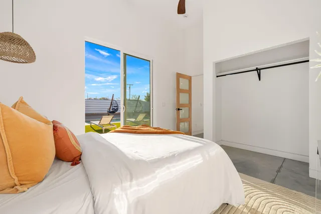 a bedroom with a bed and a window