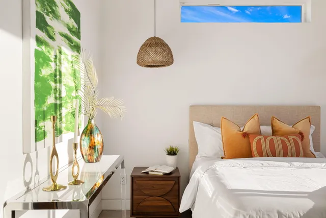 a bedroom with a bed and a painting on the wall