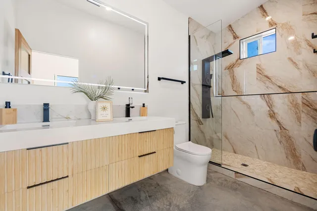 a bathroom with a sink toilet and shower