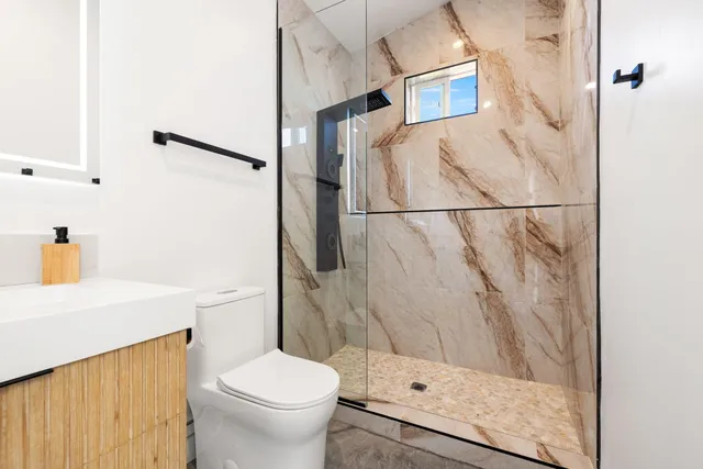 a bathroom with a sink toilet and shower