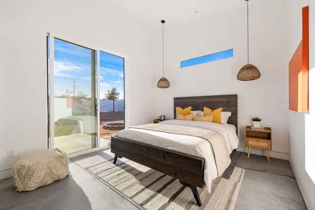 a bedroom with a bed and a mirror