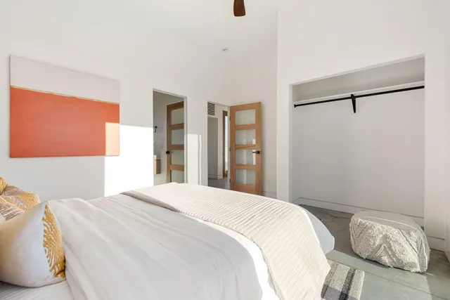 a bedroom with a bed and a window