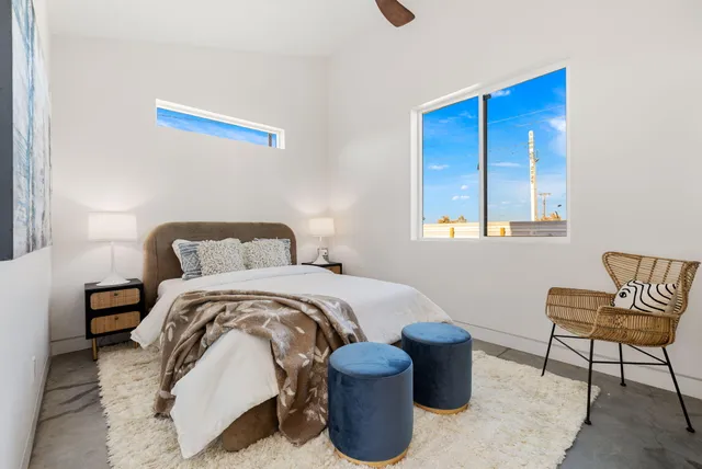 a bedroom with a bed and a chair