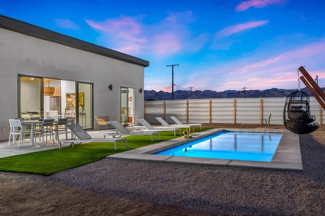 a view of yard with swimming pool and sitting area