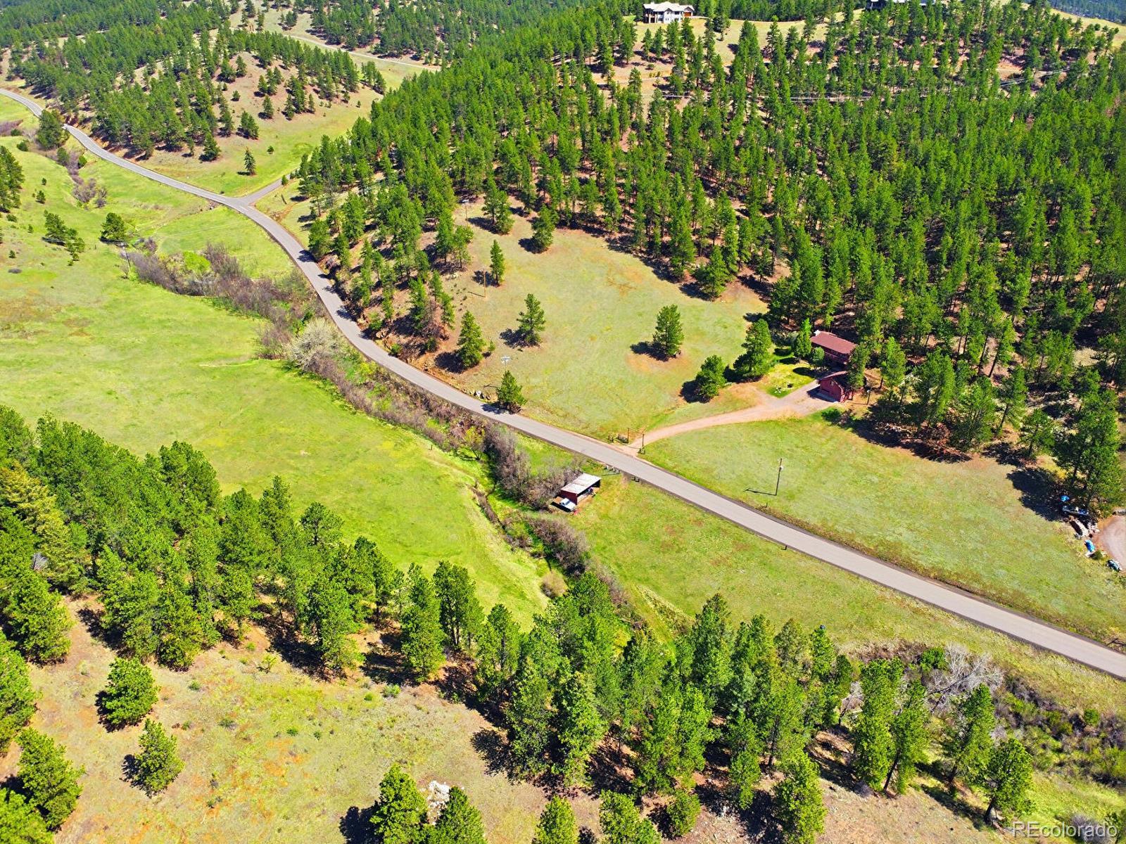 2830 Kerr Gulch Road Evergreen, CO 80439 - Photo 5 of 48 a view of a yard with an ocean view