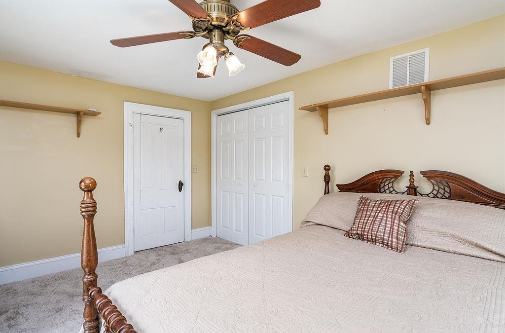 150 Ridgemore Drive Raphine, VA 24472 - Photo 45 of 75 a bedroom with a bed and a chandelier